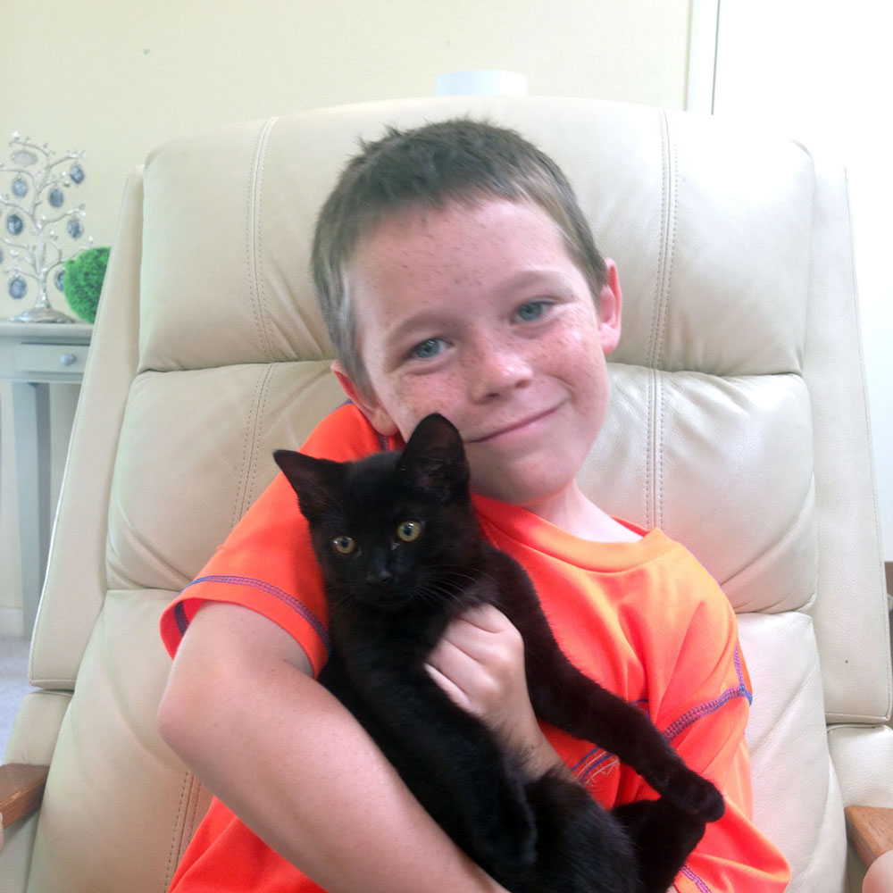 Jack says goodbye with new cat Oscar (Photograph by Rose Henderson)